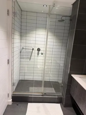 a shower with a glass door in a bathroom at Enzo Stay -The Matrix 505 , Century City in Cape Town