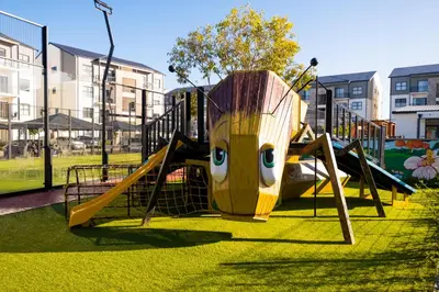 a playground with a slide with a character on it at #AlimamaSpaces The Manson's Fynbos in Cape Town