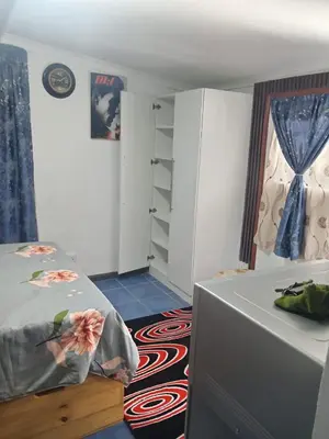 a bedroom with a bed and a dresser in it at One Bed Room Apartment 1A in Cape Town