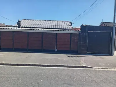a red brick building with a gate on a street at One Bed Room Apartment 1A in Cape Town