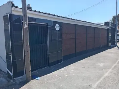 a building with a gate and a sign on it at One Bed Room Apartment 1A in Cape Town