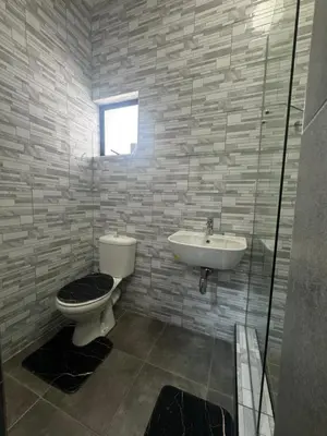 a bathroom with a toilet and a sink at kitty guest house in Bellville
