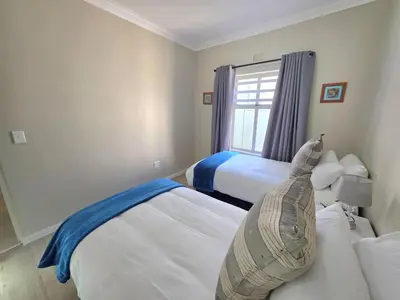 a bedroom with two beds and a window at 2 Bedroom house at Tweespruit - Pet friendly in Stellenbosch