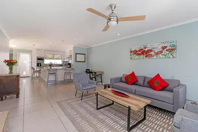 a living room with a couch and a table at The Woodbridge Hideaway in Cape Town