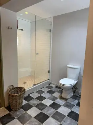 a bathroom with a toilet and a glass shower at Pepler House in Franschhoek