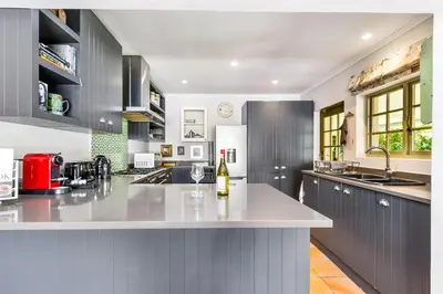 a kitchen with a bottle of wine on a counter at Pepler House in Franschhoek