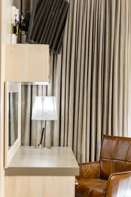 a lamp sitting on a table next to a chair at Avemore Eikehoff no 2 in Stellenbosch