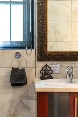 a bathroom with a sink and a mirror at Avemore Eikehoff no 2 in Stellenbosch