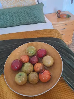 a bowl of different types of vegetables on a bed at Boutique Inn - Quintessence in Gordonʼs Bay