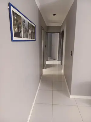 a hallway with white walls and a picture on the wall at Capetown Adilo Villa in Cape Town