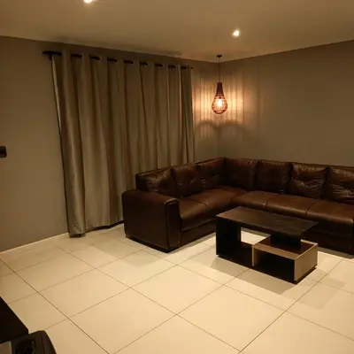a living room with a couch and a coffee table at Capetown Adilo Villa in Cape Town