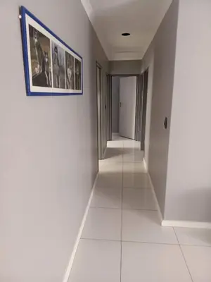 a hallway with white walls and a picture on the wall at Capetown Adilo Villa in Cape Town