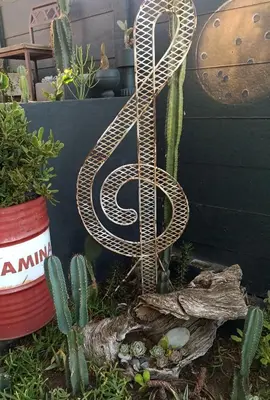 a metal letter s in a garden with cactus at Anna's Studio in Strand