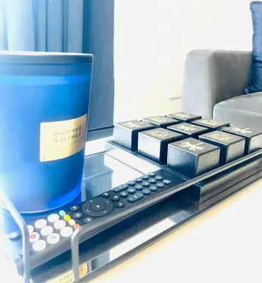 a remote control and a cup on a counter at 144 Mayfair Discerning Luxury and Ultimate Comfort in Cape Town