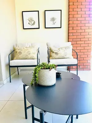 a coffee table with a potted plant on top of it at 144 Mayfair Discerning Luxury and Ultimate Comfort in Cape Town