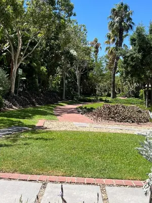 a walkway in a park with trees and grass at 144 Mayfair Discerning Luxury and Ultimate Comfort in Cape Town