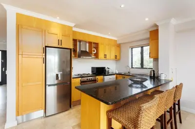 a kitchen with a stainless steel refrigerator and cabinets at Pearl Valley Golf Estate, Cedar Point 4A in Simondium