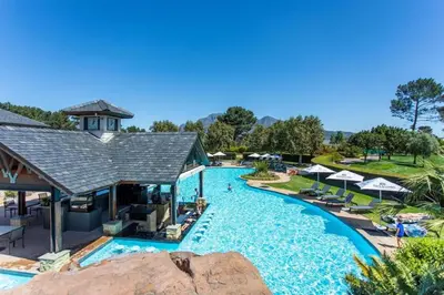 a pool at a resort with chairs and umbrellas at Pearl Valley Golf Estate, Cedar Point 4A in Simondium