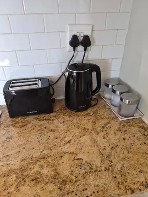 a kitchen counter with a coffee pot and a toaster at Secure Modern stay at 41 on Kennington in Parklands