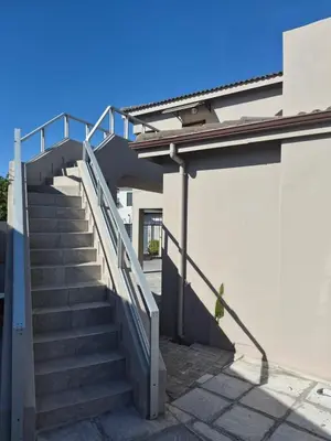 a stairway leading up to a building with a door at Secure Modern stay at 41 on Kennington in Parklands