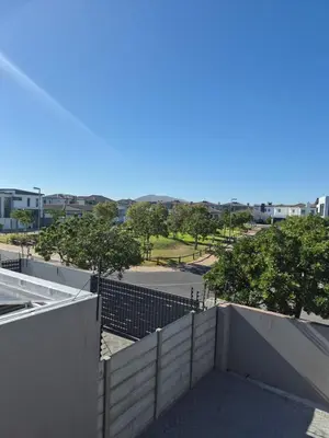 a view of a building with a fence and trees at Secure Modern stay at 41 on Kennington in Parklands