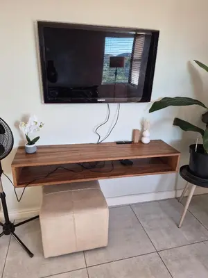 a flat screen tv on top of a wooden table at Secure Modern stay at 41 on Kennington in Parklands