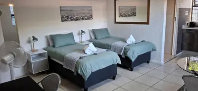 a room with two beds with pillows on them at Cozy Quarters Self-Catering Accommodation in Bellville