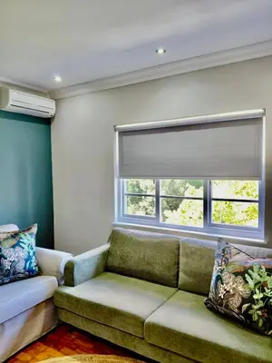 a living room with a couch and a window at The Botanic Venus in Paarl