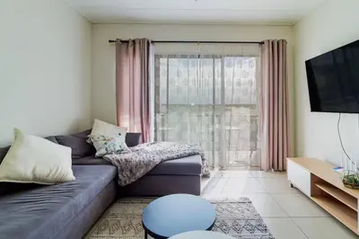 a living room with a couch and a large window at #AlimamaSpaces Thando's Fynbos in Cape Town