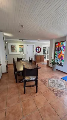 a large living room with a table and chairs at TheBlueDoor in Greyton