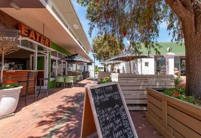 a chalkboard sign in front of a restaurant at TwentyFour 17 Inn in Hermanus