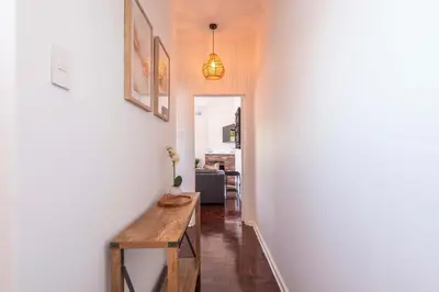 a hallway with a wooden table in a room at First floor Claremont Studio apartment in Cape Town