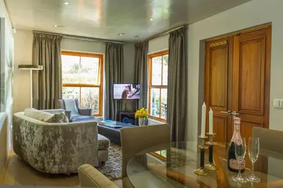 a living room with a couch and a table at Swan Cottage in Kylemore