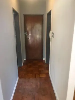 a hallway with a door and a wooden floor at Newly renovated Stellies 2 Bed apt in heart of Stellies! in Stellenbosch