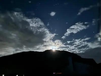 a view of the sun setting over a mountain at Silversands Serenity in Bettyʼs Bay