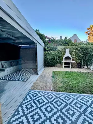 an open garage with a rug on a wooden deck at 3at33 CT in Cape Town