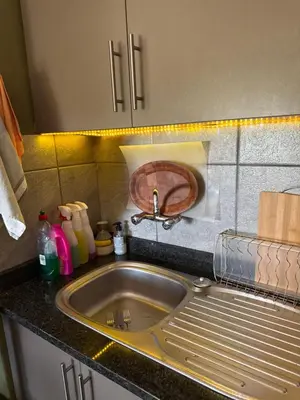 a kitchen counter with a sink and a sink at Balcony mountain views free fibre-wifi aircon and parking in Wellington