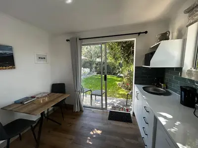 a kitchen with a table and a sink and a window at Dove Cottage in Oakdale