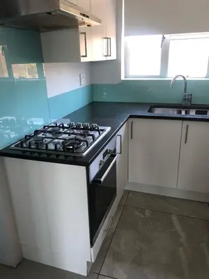 a kitchen with a stove and a sink at Central and close to the beach in Cape Town