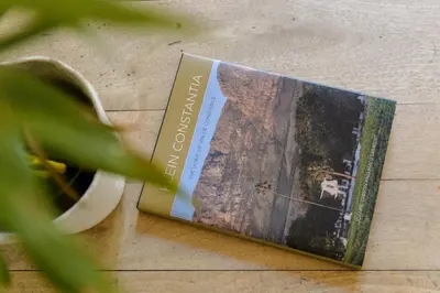 a book sitting on top of a wooden floor at Am Flus- at the river in Stellenbosch