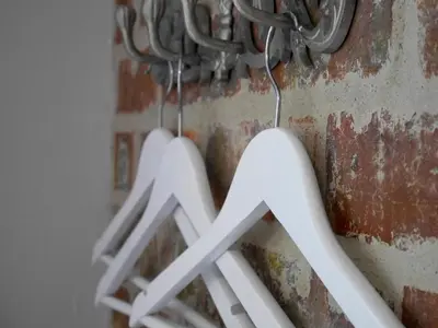 a group of hangers hanging on a wall at The Garden Shed Guest House in Wellington