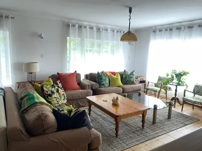 a living room with a couch and a coffee table at Salty Leaves in Hermanus