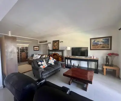 a living room with a couch and a table at Paarl View House in Paarl