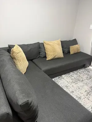 a gray couch with two pillows on it at Modern stay overlooking Durbanville wine country in Durbanville