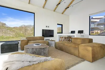 a living room with a couch and a table at Nowhere Els in Rooiels