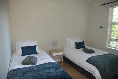 two beds sitting next to each other in a bedroom at 2-Bedroom Private Garden Flat, Durbanville in Durbanville