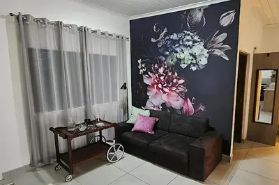 a living room with a couch and a table at Bed and Biscuits in Windmeul