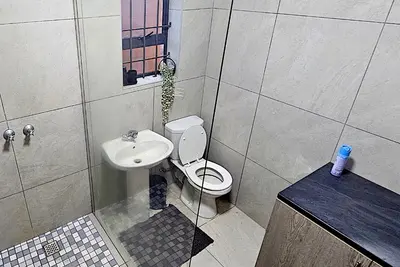 a bathroom with a toilet and a sink at Bed and Biscuits in Windmeul
