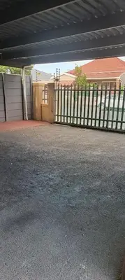 a garage with a fence in front of a house at Accomodation in Cape Town in Goodwood