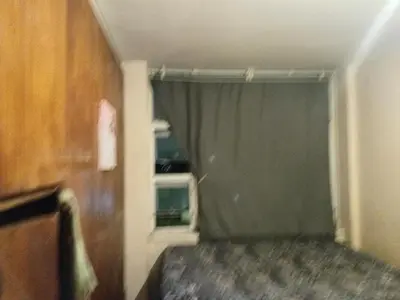 a room with a bed and a window with a curtain at Emilia in Bellville